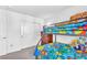 ' bedroom with a bunk bed, colorful bedding, and stuffed animals at 6952 Crimson Shadow St, North Las Vegas, NV 89086