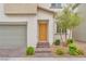 Close-up of the home's front door with brick entry and landscaped bushes at 6952 Crimson Shadow St, North Las Vegas, NV 89086