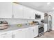 Clean kitchen features white cabinets, gray countertops, and stainless steel appliances at 6952 Crimson Shadow St, North Las Vegas, NV 89086