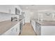 Spacious kitchen featuring stainless steel appliances, light wood floors, and a stone countertop island at 6952 Crimson Shadow St, North Las Vegas, NV 89086