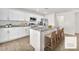 Bright kitchen featuring white cabinets, stainless steel appliances, and an island with seating at 6952 Crimson Shadow St, North Las Vegas, NV 89086