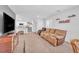 Open living space with a large sofa and seamless access to the kitchen area at 6952 Crimson Shadow St, North Las Vegas, NV 89086