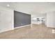 Spacious living room with wood floors and neutral paint, leading into kitchen area at 6952 Crimson Shadow St, North Las Vegas, NV 89086
