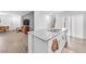 Spacious living room with kitchen island, wood floors, and plenty of natural light at 6952 Crimson Shadow St, North Las Vegas, NV 89086