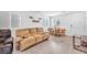 Comfortable living room with a large sofa, dining table, and wood flooring at 6952 Crimson Shadow St, North Las Vegas, NV 89086