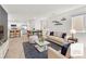 Open-concept living room featuring a dining area and modern kitchen with stainless appliances at 6952 Crimson Shadow St, North Las Vegas, NV 89086