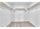 Walk-in closet featuring neutral carpet, white walls, and shelving at 6952 Crimson Shadow St, North Las Vegas, NV 89086