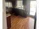 Bright kitchen featuring wooden floors and sliding glass doors to the backyard at 7098 Forest Vista St, Las Vegas, NV 89147