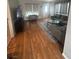Living room featuring hardwood floors, modern decor, and comfortable seating at 7098 Forest Vista St, Las Vegas, NV 89147
