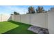 A fenced backyard has synthetic grass and a small brick patio for outdoor enjoyment and low maintenance at 7204 N Decatur Blvd, North Las Vegas, NV 89131