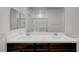 Bathroom featuring double sinks with dark wood cabinets and a glass enclosed shower at 7204 N Decatur Blvd, North Las Vegas, NV 89131