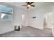 Bright bedroom with ceiling fan, TV mount, and neutral carpet at 7204 N Decatur Blvd, North Las Vegas, NV 89131