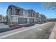 Attractive townhome exteriors featuring private garages and balconies, and well-kept landscaping on a sunny day at 7204 N Decatur Blvd, North Las Vegas, NV 89131
