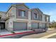 Townhome exteriors with gray garages, colorful shutters, and manicured landscaping on a sunny day at 7204 N Decatur Blvd, North Las Vegas, NV 89131