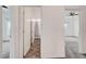 Hallway view featuring neutral walls, carpeted floors, and bathroom with tile flooring at 7204 N Decatur Blvd, North Las Vegas, NV 89131