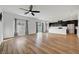Open-concept living area featuring hardwood floors, large windows, recessed lighting, and a view of the kitchen at 7204 N Decatur Blvd, North Las Vegas, NV 89131