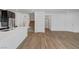 Open concept living area with wood floors, white walls, and staircase at 7204 N Decatur Blvd, North Las Vegas, NV 89131