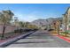 Scenic street view features modern townhomes, well-maintained landscaping, and mountain views in the distance at 7204 N Decatur Blvd, North Las Vegas, NV 89131