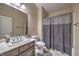 Neutral bathroom features a shower, vanity and ample counter space and a large mirror at 7311 Velvet Sky St, Las Vegas, NV 89131