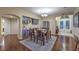 Spacious dining room featuring hardwood floors, bar with wine fridge, and views of the foyer at 7311 Velvet Sky St, Las Vegas, NV 89131