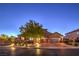 Beautiful home exterior featuring a well-manicured lawn, mature tree, and an inviting paver driveway leading to a two-car garage at 7311 Velvet Sky St, Las Vegas, NV 89131