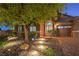 Inviting home exterior with stone pathway, lush landscaping, and a decorative arched front door enhanced by exterior lighting at 7311 Velvet Sky St, Las Vegas, NV 89131