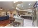 Open-concept kitchen with granite countertops, stainless appliances, and bar seating area at 7311 Velvet Sky St, Las Vegas, NV 89131