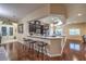Open kitchen and bar area with dark wood cabinets, stainless appliances, and seating for three at 7311 Velvet Sky St, Las Vegas, NV 89131