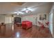 Spacious living room features beautiful wood floors, tray ceiling with fans, and plentiful seating at 7311 Velvet Sky St, Las Vegas, NV 89131