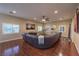 Large living room featuring hardwood floors, plantation shutters, and comfortable furniture at 7311 Velvet Sky St, Las Vegas, NV 89131