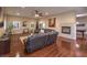 Spacious living room featuring a stone fireplace, hardwood floors, and comfortable seating area at 7311 Velvet Sky St, Las Vegas, NV 89131