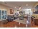Open concept living area with hardwood floors, plush seating, and access to the kitchen at 7311 Velvet Sky St, Las Vegas, NV 89131