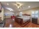 Spacious main bedroom features a seating area, wood floors, ceiling fan, and windows at 7311 Velvet Sky St, Las Vegas, NV 89131