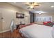 Bright main bedroom boasts hardwood floors, a ceiling fan, and a relaxing seating area at 7311 Velvet Sky St, Las Vegas, NV 89131