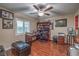 Cozy office with wood floors, a ceiling fan, and natural light from a window at 7311 Velvet Sky St, Las Vegas, NV 89131