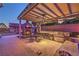 Enjoy this outdoor kitchen, complete with a stone fireplace and a built-in grill, ideal for entertaining at 7311 Velvet Sky St, Las Vegas, NV 89131