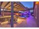 Outdoor patio with a built-in outdoor kitchen, dining area and pool with ambient lighting at 7311 Velvet Sky St, Las Vegas, NV 89131