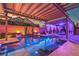 Inviting backyard pool with built-in lighting features a cozy daybed for ultimate relaxation at 7311 Velvet Sky St, Las Vegas, NV 89131
