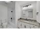 Bathroom with modern fixtures, black hardware, and tiled shower/tub combo at 8301 Shad Bush Ave, Las Vegas, NV 89149