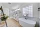 Spa-like bathroom featuring a soaking tub, walk-in shower, and modern double vanity for a luxurious retreat at 8301 Shad Bush Ave, Las Vegas, NV 89149