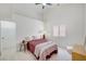 Vaulted ceiling bedroom featuring a ceiling fan, a window for natural light, and neutral carpeting at 8301 Shad Bush Ave, Las Vegas, NV 89149