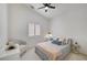 Bedroom featuring a ceiling fan, a window for natural light, and neutral carpeting at 8301 Shad Bush Ave, Las Vegas, NV 89149