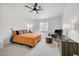 Bright bedroom featuring a ceiling fan, a window for natural light, and neutral carpeting at 8301 Shad Bush Ave, Las Vegas, NV 89149