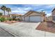 Charming single-story home featuring a three-car garage and desert landscaping at 8301 Shad Bush Ave, Las Vegas, NV 89149