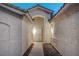 Covered entry with custom metal security gate and side windows at 8301 Shad Bush Ave, Las Vegas, NV 89149