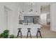 Kitchen island featuring sleek black stools and modern design flowing into the living space at 8301 Shad Bush Ave, Las Vegas, NV 89149