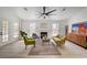Living room featuring fireplace, bright windows and wood flooring at 8301 Shad Bush Ave, Las Vegas, NV 89149