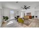 Bright living room with modern fan, fireplace, and view of the backyard pool at 8301 Shad Bush Ave, Las Vegas, NV 89149