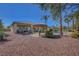 Expansive backyard with gravel, lush plants, tiki hut, and a swimming pool, creating a private oasis at 8370 Unicorn St, Las Vegas, NV 89131