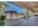 Lush backyard with a sparkling pool, tiki hut, and covered patio perfect for outdoor entertaining at 8370 Unicorn St, Las Vegas, NV 89131